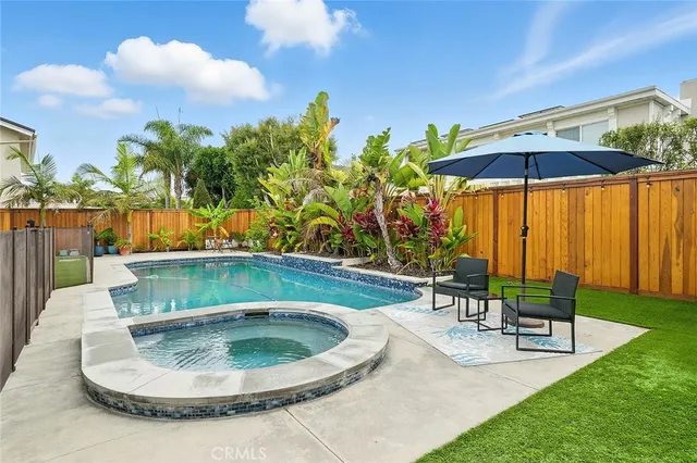 a view of a house with pool and chairs