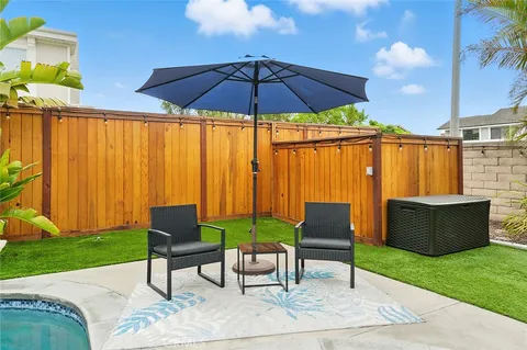a view of backyard with patio and outdoor seating