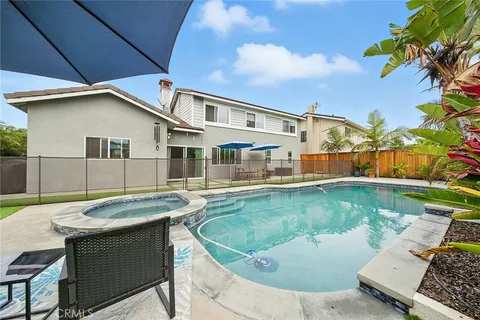 a view of an house with swimming pool and a yard
