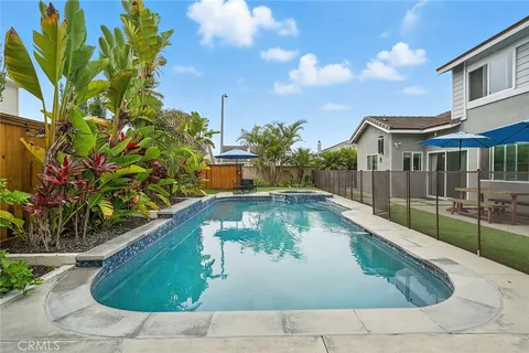 a swimming pool with outdoor seating and yard