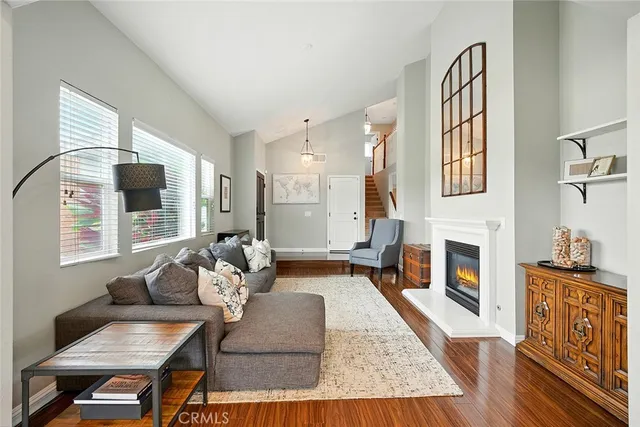 a living room with fireplace furniture and a wooden floor