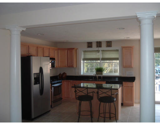 1975 Middlesex Street, Unit 7 Lowell, MA 01851 - Photo 2 of 6 a kitchen with a table and chairs