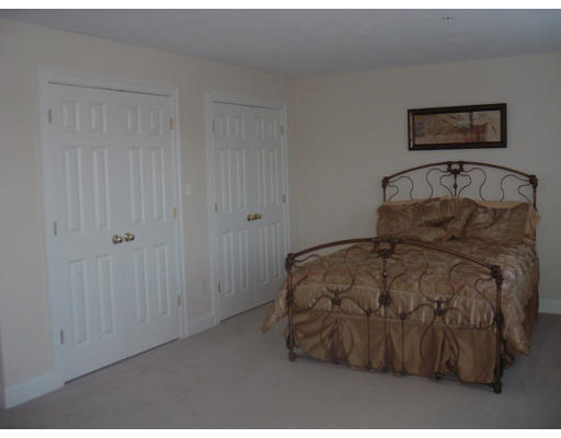 1975 Middlesex Street, Unit 7 Lowell, MA 01851 - Photo 4 of 6 a bedroom with a bed and painting on the wall