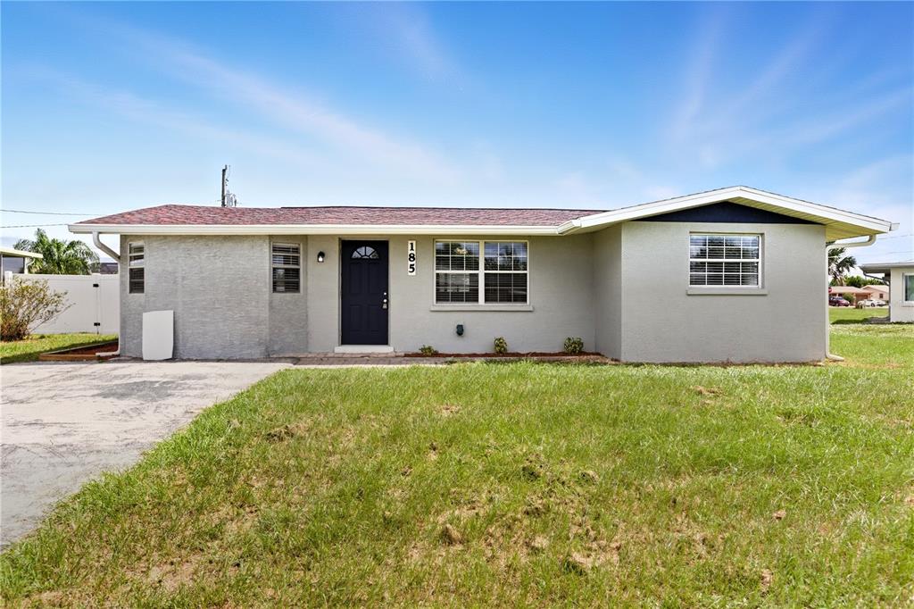a front view of house with yard and trees