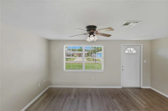wooden floor in an empty room with a window
