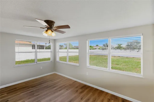 a view of a kitchen with wooden floor and a kitchen space