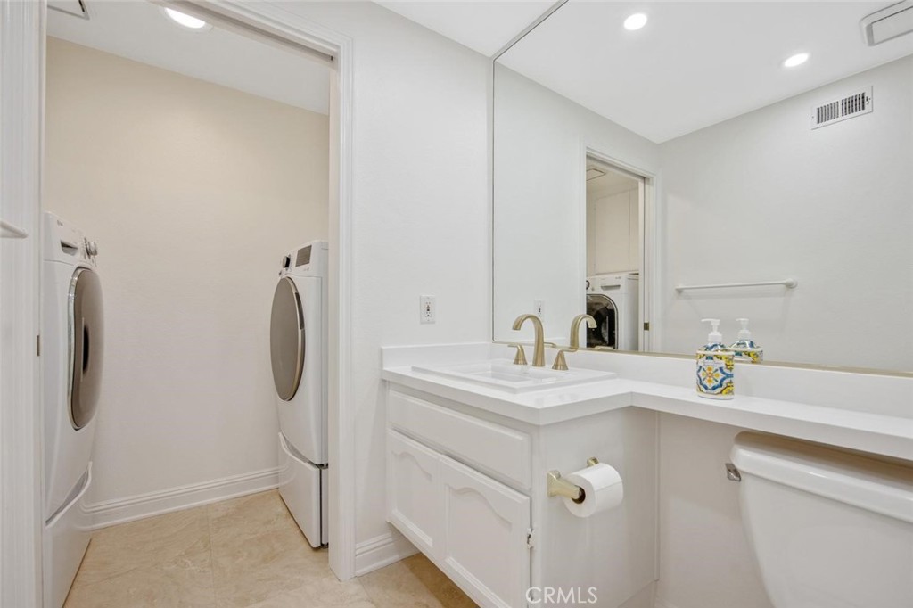 5974 Ruthwood Drive Calabasas, CA 91302 - Photo 19 of 30 a bathroom with a sink toilet and a mirror