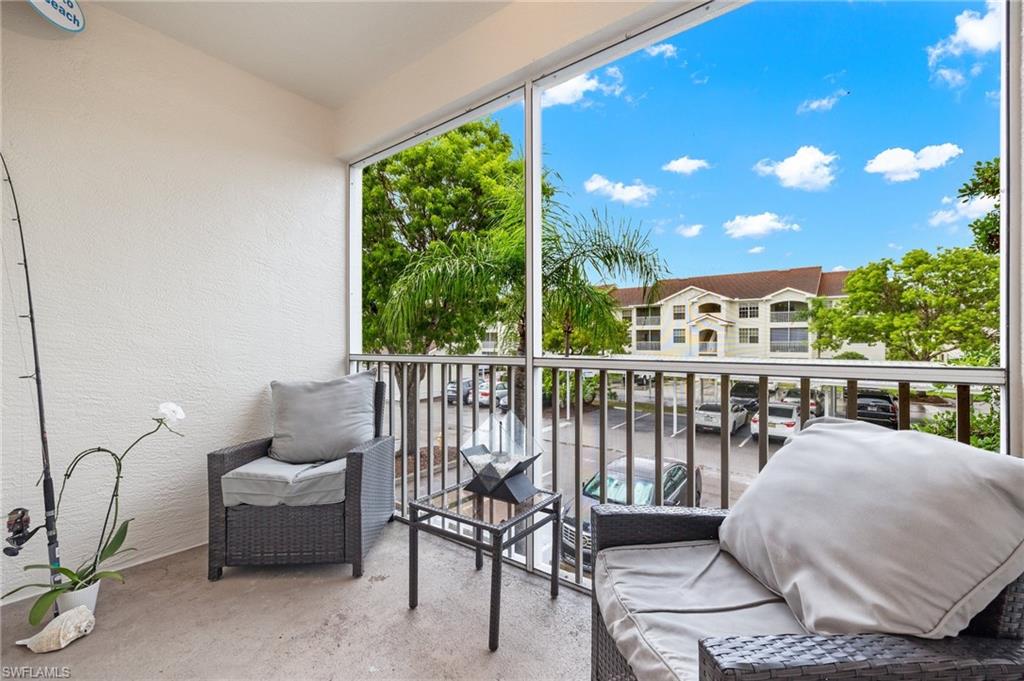 4635 St Croix Lane, Unit 1222 Naples, FL 34109 - Photo 12 of 20 a balcony with furniture and garden view