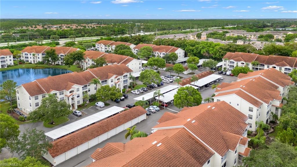 4635 St Croix Lane, Unit 1222 Naples, FL 34109 - Photo 17 of 20 an aerial view of residential houses with outdoor space and river