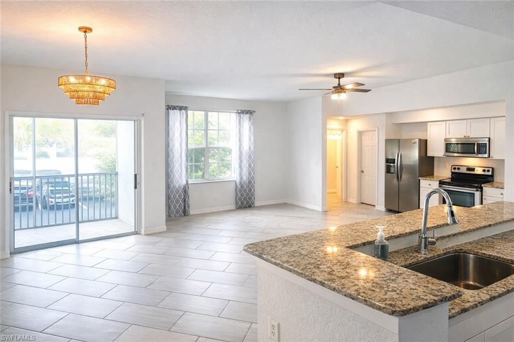 4635 St Croix Lane, Unit 1222 Naples, FL 34109 - Photo 3 of 20 a kitchen with stainless steel appliances granite countertop a sink and a counter space