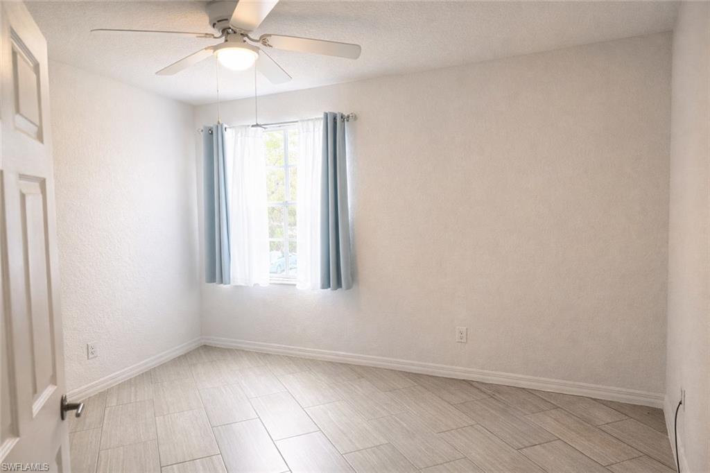 4635 St Croix Lane, Unit 1222 Naples, FL 34109 - Photo 9 of 20 an empty room with a window and a fan