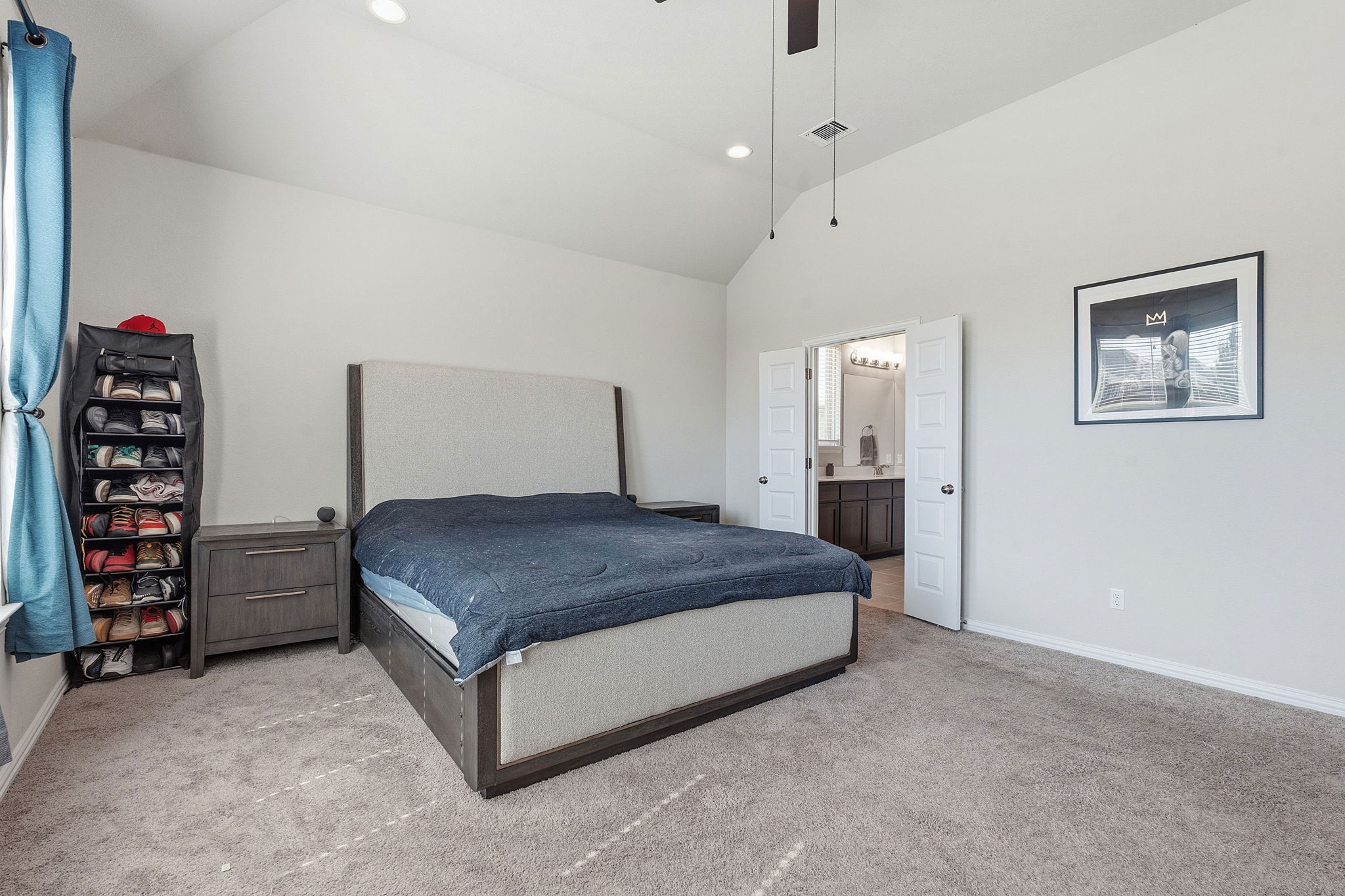 12616 Twisted Root Drive Manchaca, TX 78652 - Photo 15 of 36 The primary suite is your secluded retreat under soaring ceilings with recessed lighting and a modern fan.