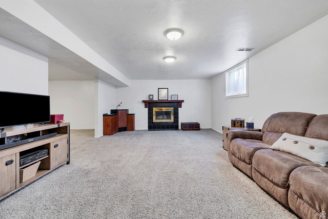 3334 Ute Road St. George, UT 84790 - Photo 26 of 40 Living area with a fireplace and light carpet