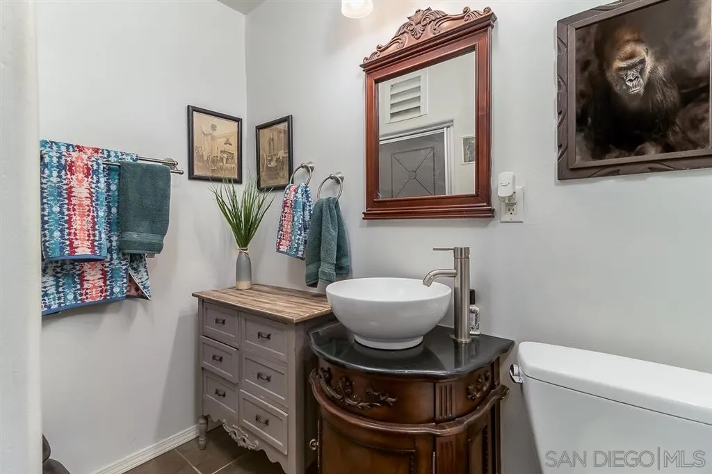 9215 Dalehurst Road Santee, CA 92071 - Photo 13 of 25 a bathroom with a toilet a sink and mirror