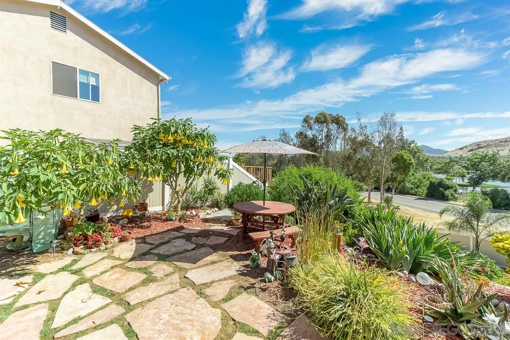 9215 Dalehurst Road Santee, CA 92071 - Photo 18 of 25 a view of a backyard with plants and lake
