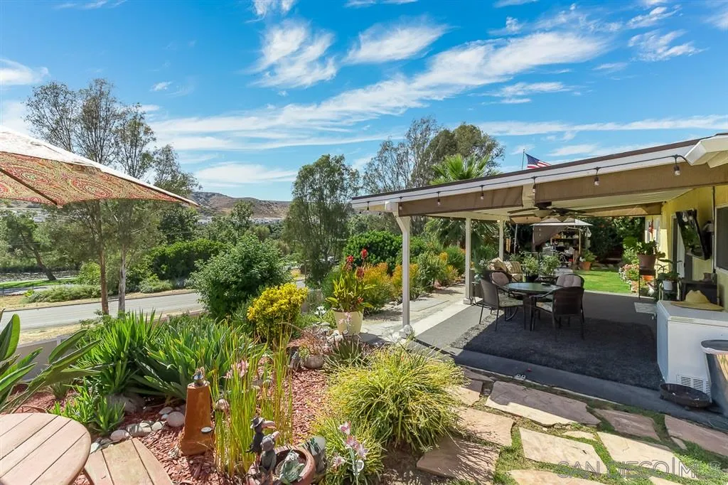 9215 Dalehurst Road Santee, CA 92071 - Photo 19 of 25 a view of a patio with table and chairs under an umbrella