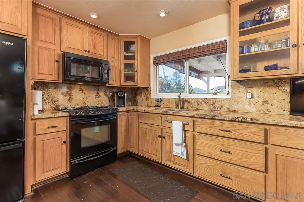 9215 Dalehurst Road Santee, CA 92071 - Photo 8 of 25 a kitchen with granite countertop cabinets stainless steel appliances and a sink