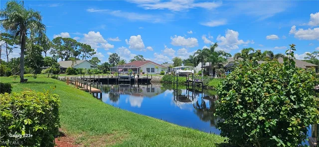 a view of a lake with a house in the background