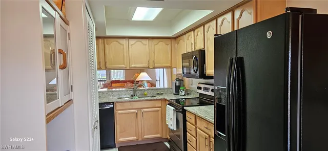 a view of a dining room with furniture and a window