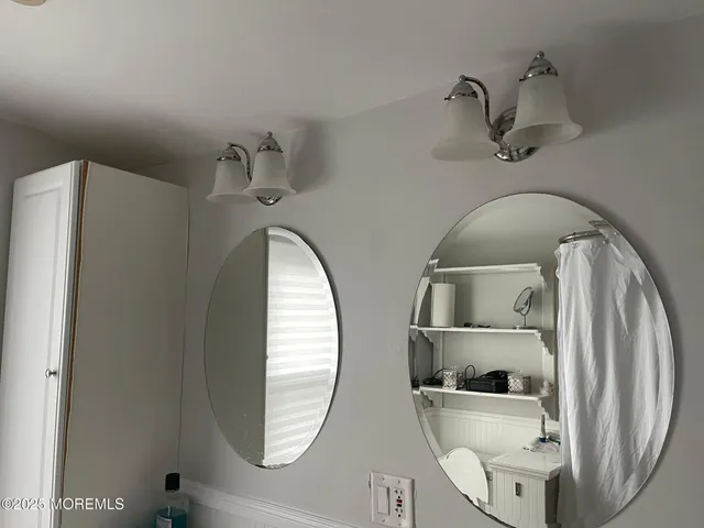 closeup of a bathroom with a sink mirror and toilet