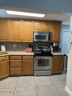 649 Hoey Avenue Long Branch, NJ 07740 - Photo 5 of 13 a kitchen with granite countertop a stove top oven microwave and cabinets