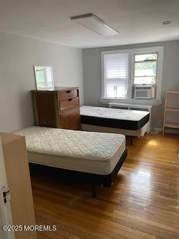 a living room with a table chairs and wooden floor