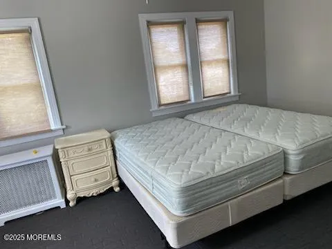 a bed sitting in a bedroom next to a window