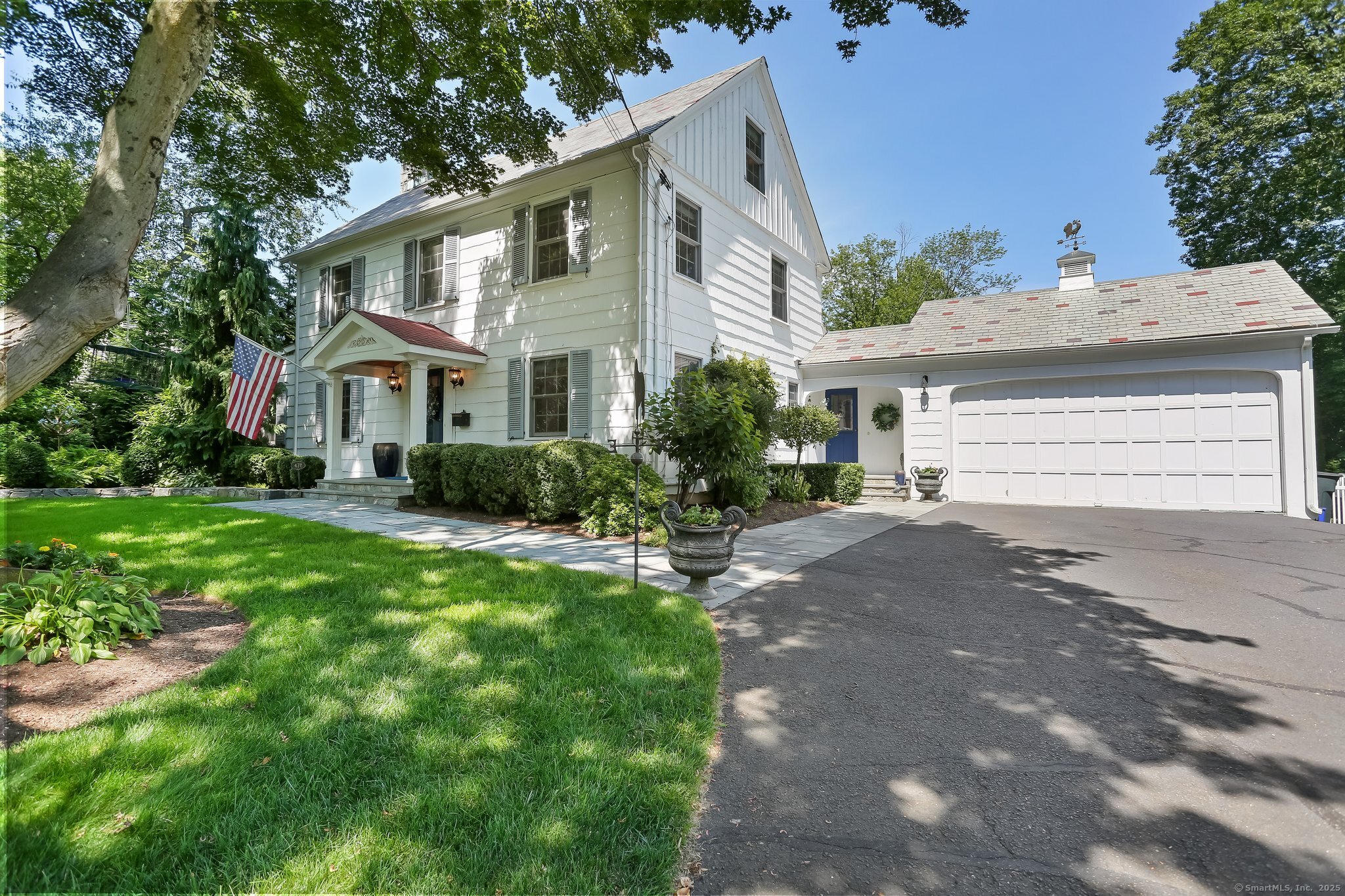 478 Crestwood Road Fairfield, CT 06824 - Photo 1 of 1 a front view of a house with a garden and plants