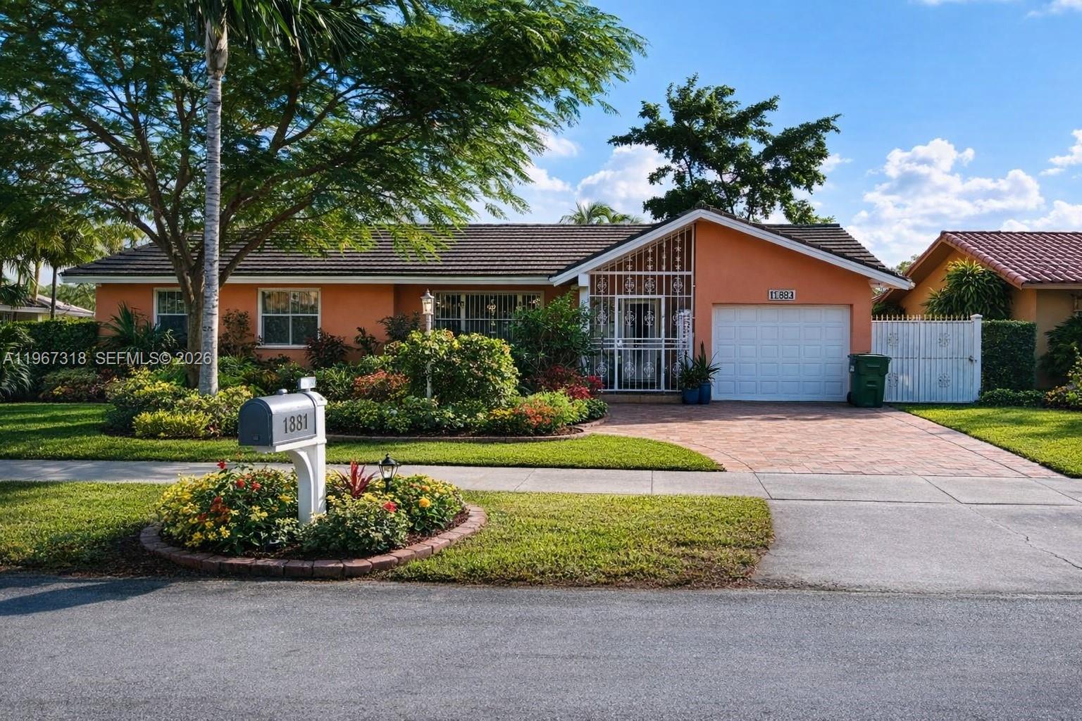 13108 Southwest 3rd Street Miami, FL 33184 - Photo 2 of 9 a front view of house with yard and green space