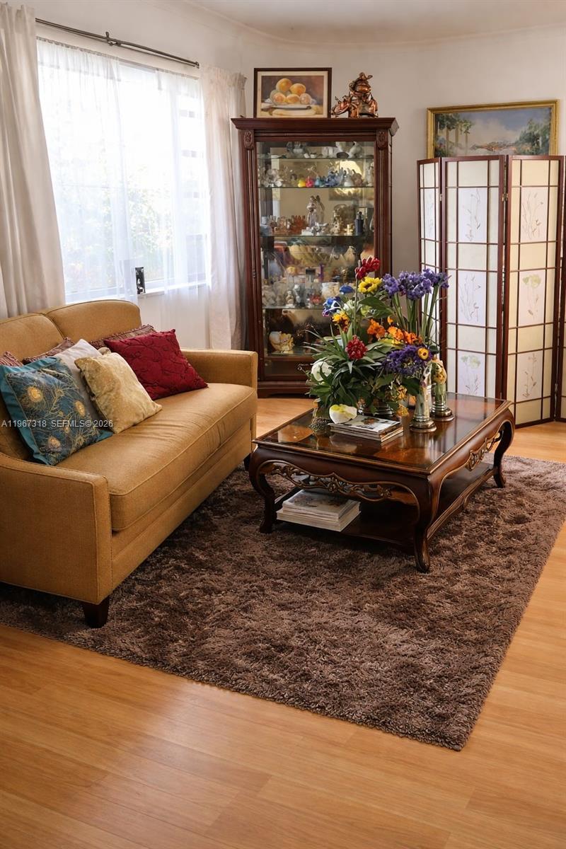 13108 Southwest 3rd Street Miami, FL 33184 - Photo 5 of 9 a living room with furniture and a floor to ceiling window