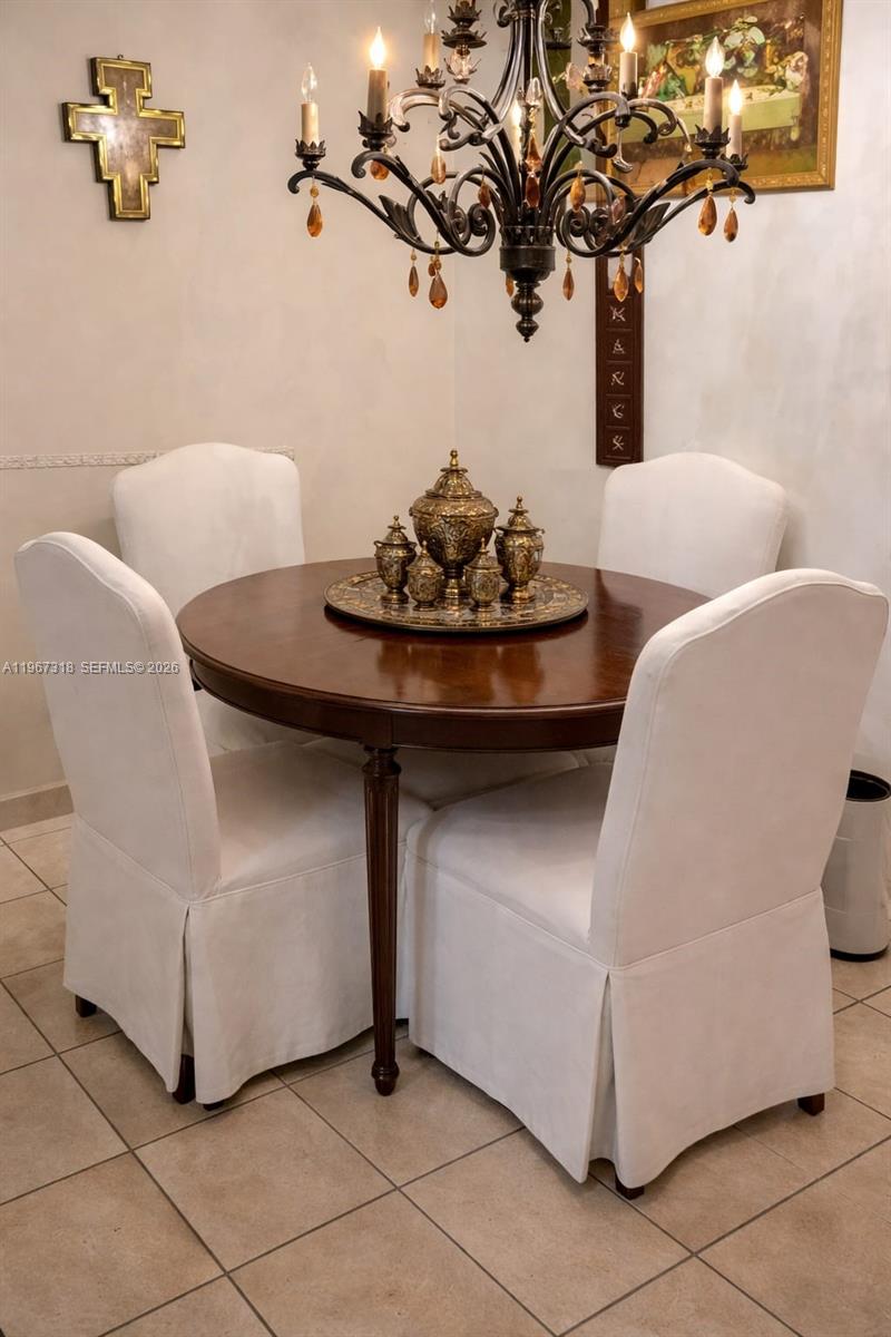 13108 Southwest 3rd Street Miami, FL 33184 - Photo 8 of 9 a dining room with furniture and a potted plant