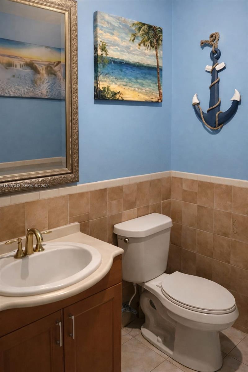 13108 Southwest 3rd Street Miami, FL 33184 - Photo 9 of 9 a bathroom with a toilet a sink and mirror