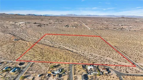 a view of mountain with sunset in background