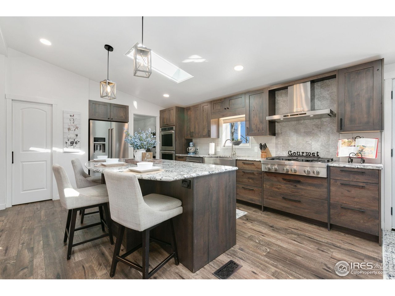 10056 County Road 76 1/2 Windsor, CO 80550 - Photo 11 of 40 Gourmet Kitchen w/ Granite Countertops/ Kitchen AId Stainless Steel Kitchen Appliances , Gas Cook top