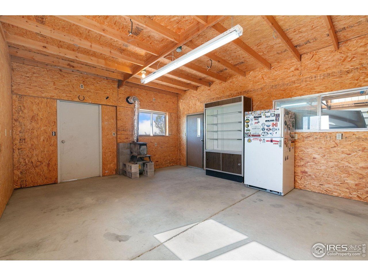 10056 County Road 76 1/2 Windsor, CO 80550 - Photo 27 of 40 Man Cave in Barn w/ Wood Burning Stove