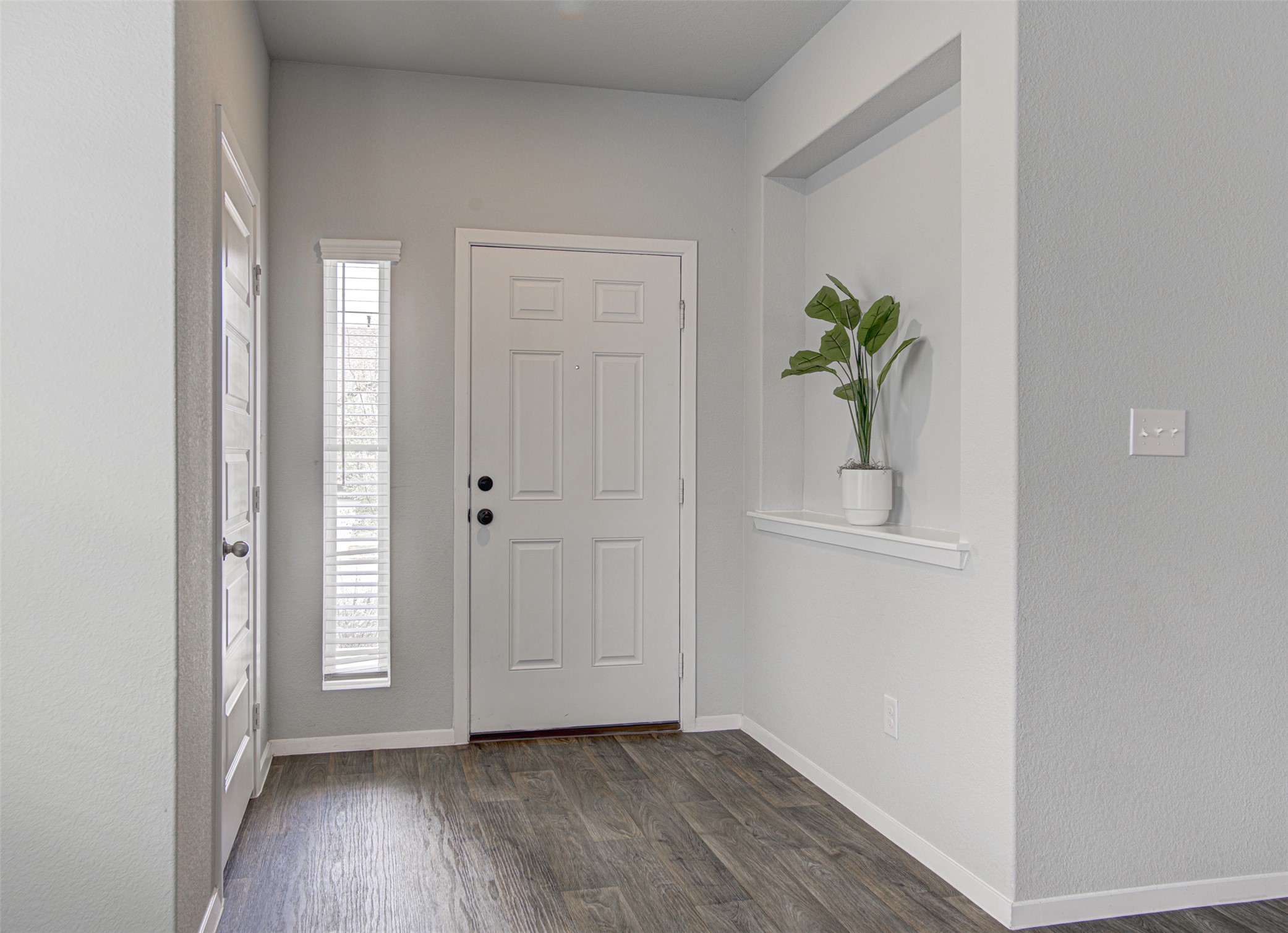 156 Tillage Road Elgin, TX 78621 - Photo 4 of 25 A well-lit entry with rich wood flooring welcomes you home.
