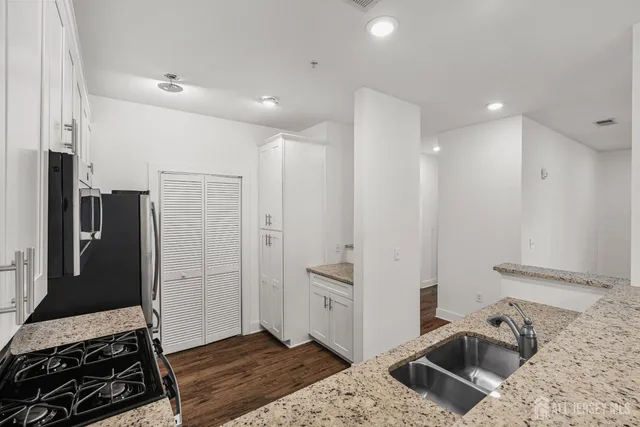 a bedroom with furniture and a rug