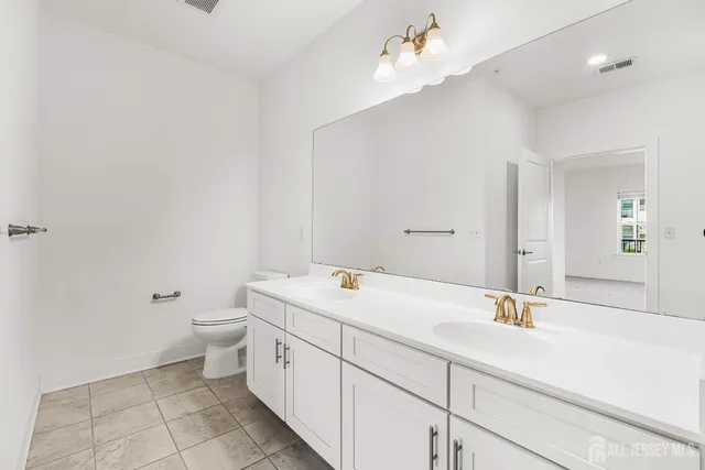 a bathroom with a sink a toilet and bathtub
