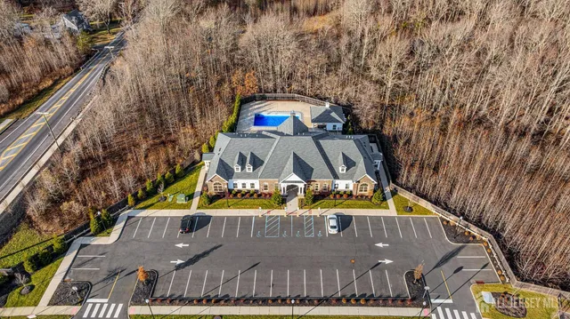 a view of a large building with a lawn chairs under an umbrella