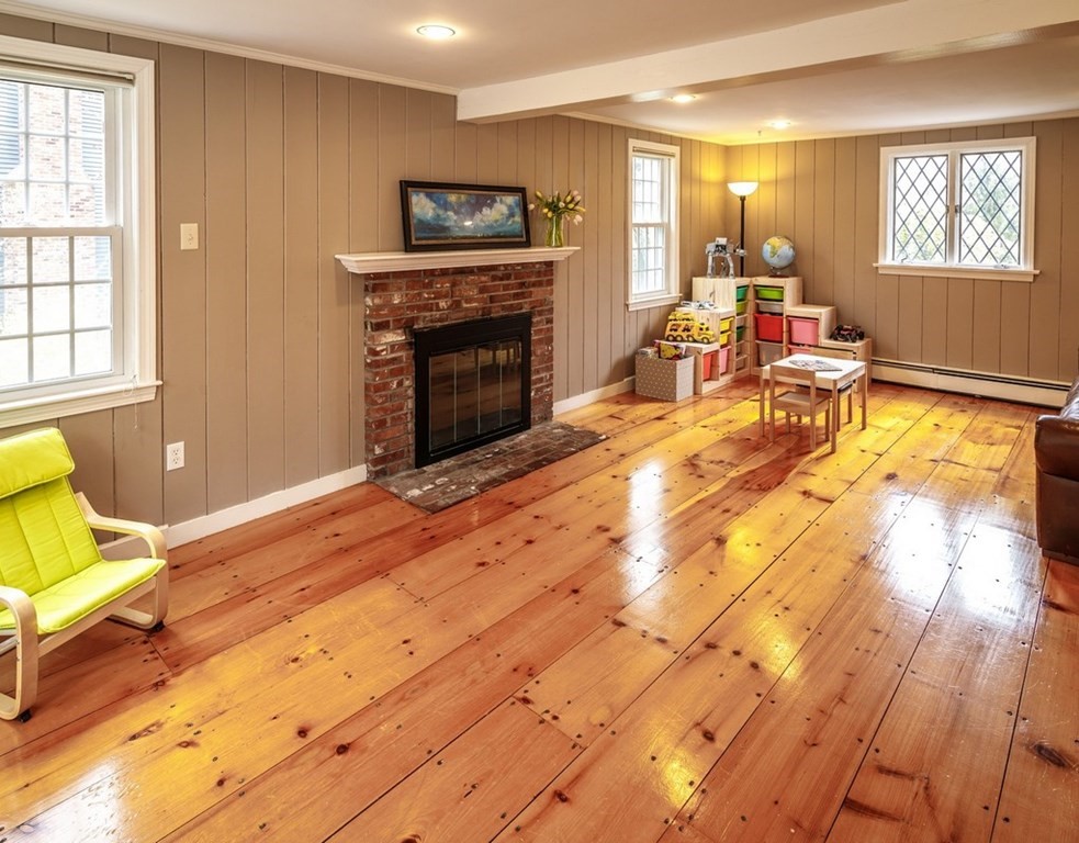 8 Olde Coach Road Westborough, MA 01581 - Photo 19 of 42 a living room with furniture a flat screen tv and a fireplace