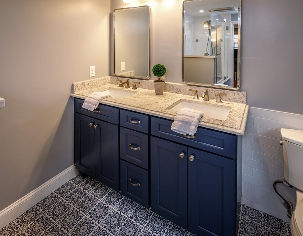 8 Olde Coach Road Westborough, MA 01581 - Photo 27 of 42 a bathroom with a granite countertop double vanity and a mirror