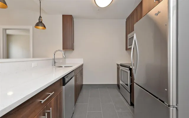 a kitchen with a sink and stainless steel appliances