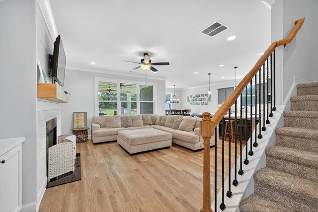 a living room with fireplace furniture and a flat screen tv