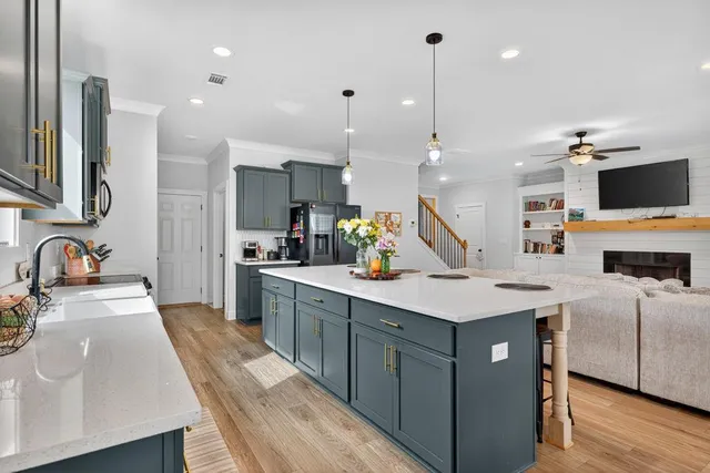 a kitchen with stainless steel appliances a sink a stove top oven a counter space and cabinets