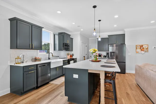 a large kitchen with kitchen island a sink counter space and stainless steel appliances