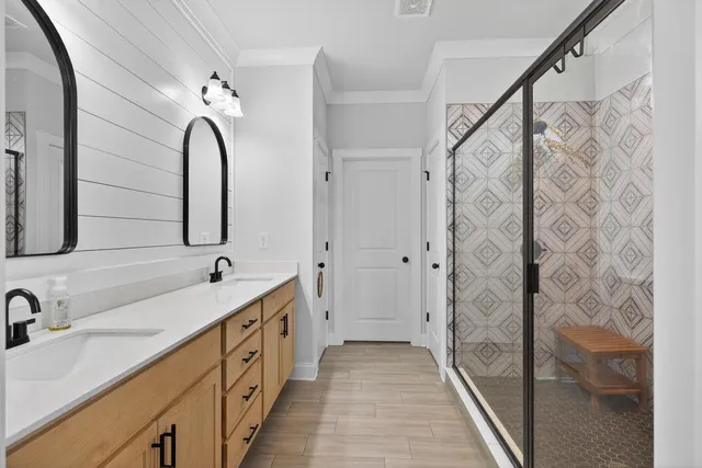 a spacious bathroom with double vanity and a mirror