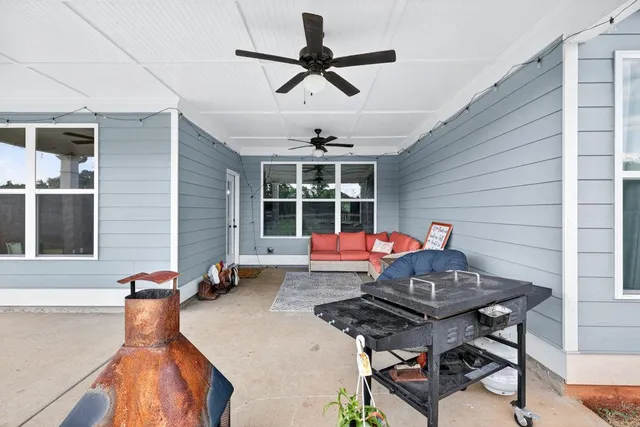 a view of a house with a backyard porch and sitting area