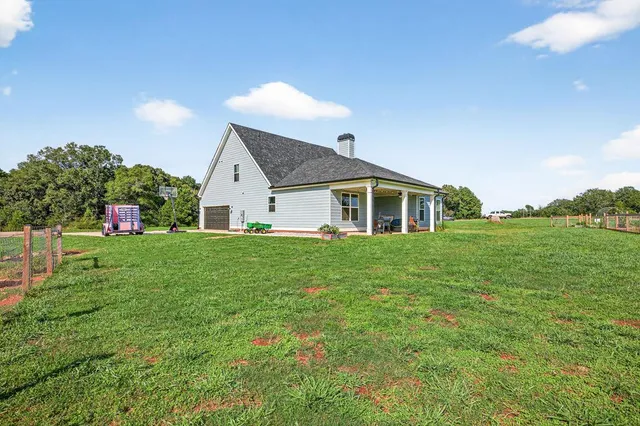 a view of a house with a backyard