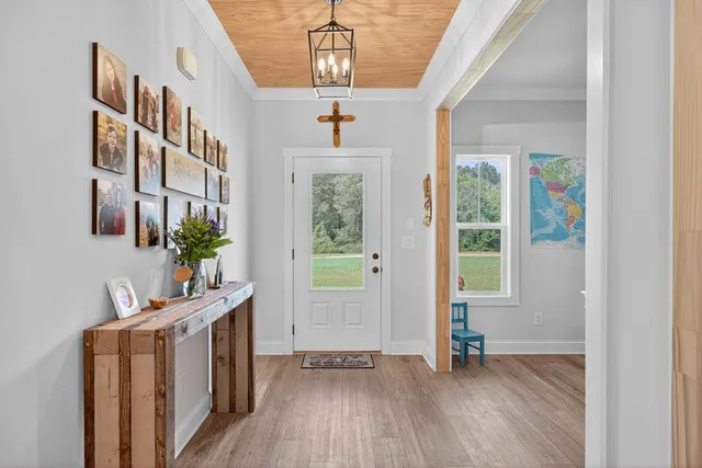 a view of an entryway with wooden floor