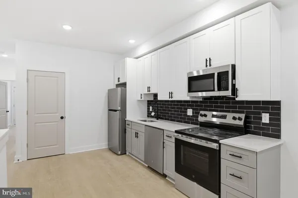 a kitchen with a stove and a microwave